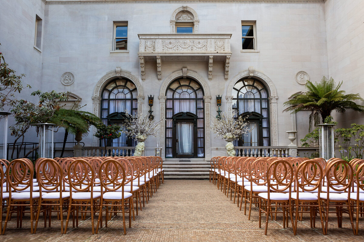San Francisco wedding photographer documents luxury ceremony at historic Flood Mansion with elegant gold chair setup