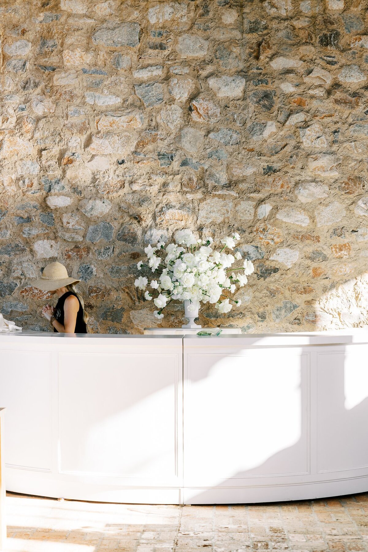 Large bar arrangement filled with luxury white blooms in flower urn at Monserate Winery designed by Snapdragon Bloom Bar.