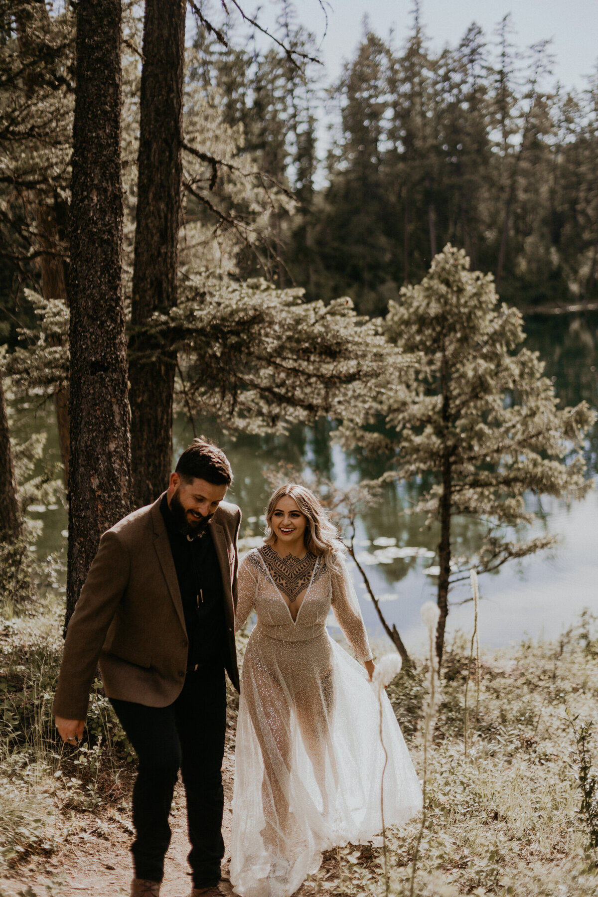 bride and groom walking together in a forest