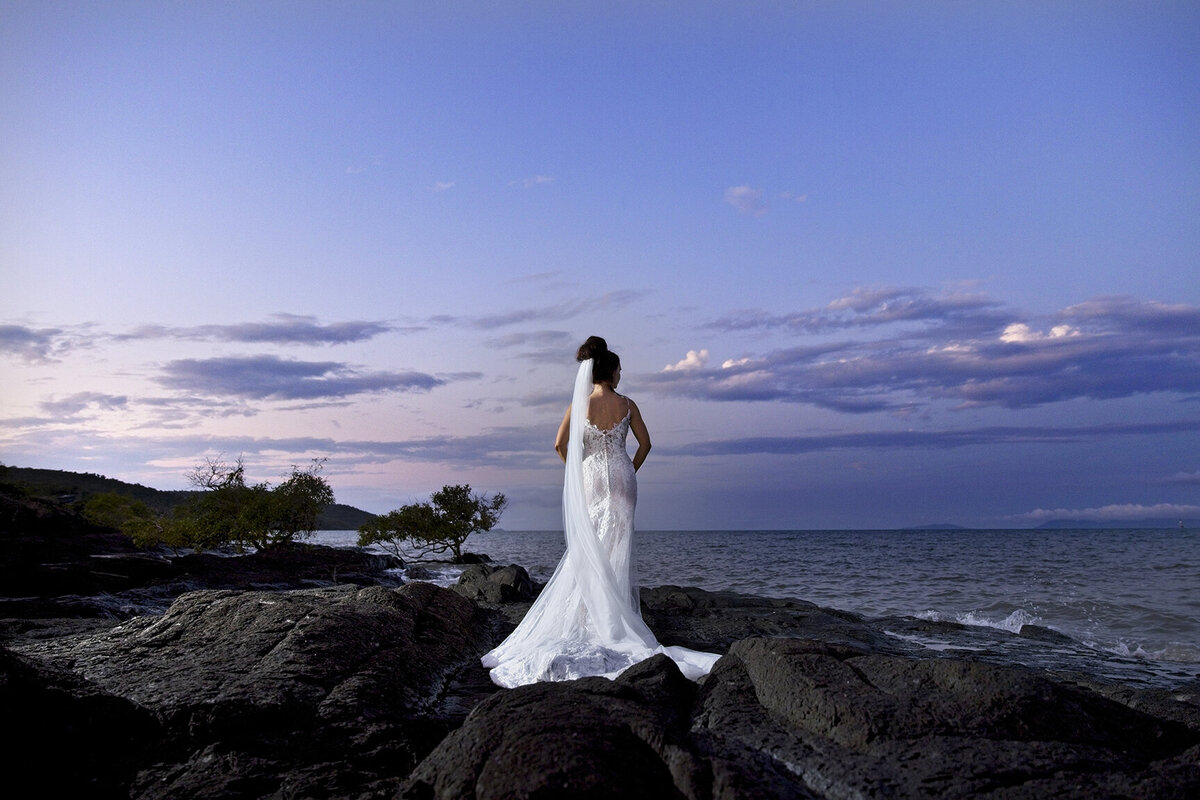 Breathtaking nighttime bridal portraits with stunning flash effects at Airlie Beach's Villa Botanica.