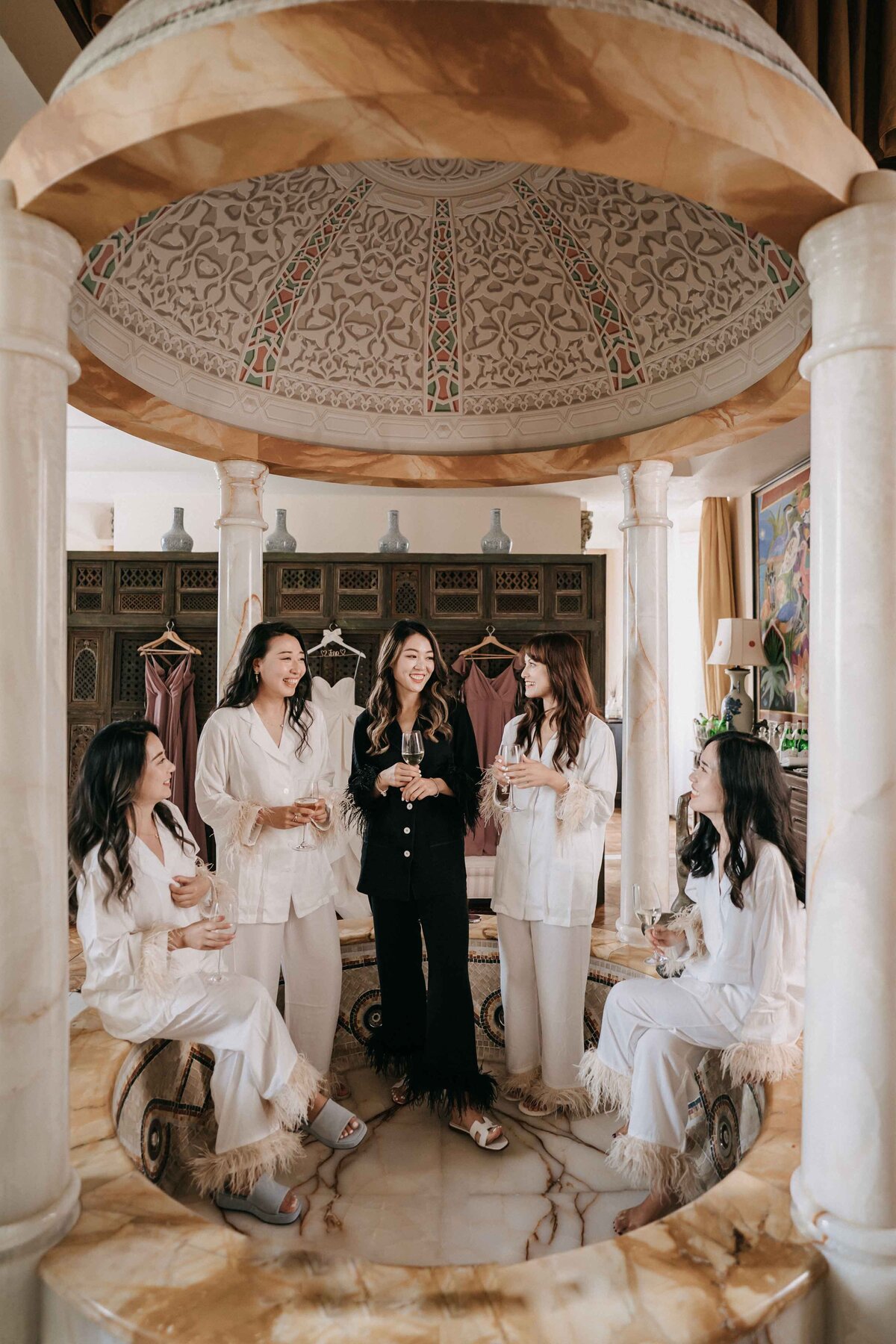 bride and the braidsmaid drinking champagne at villa mangiacane
