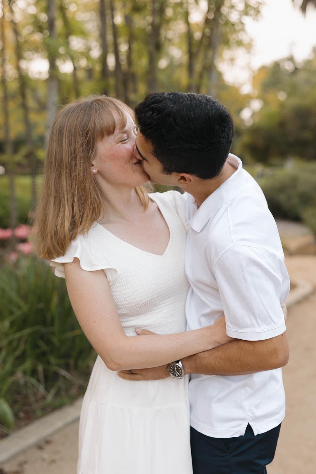 Engaged couple laughing in a garden