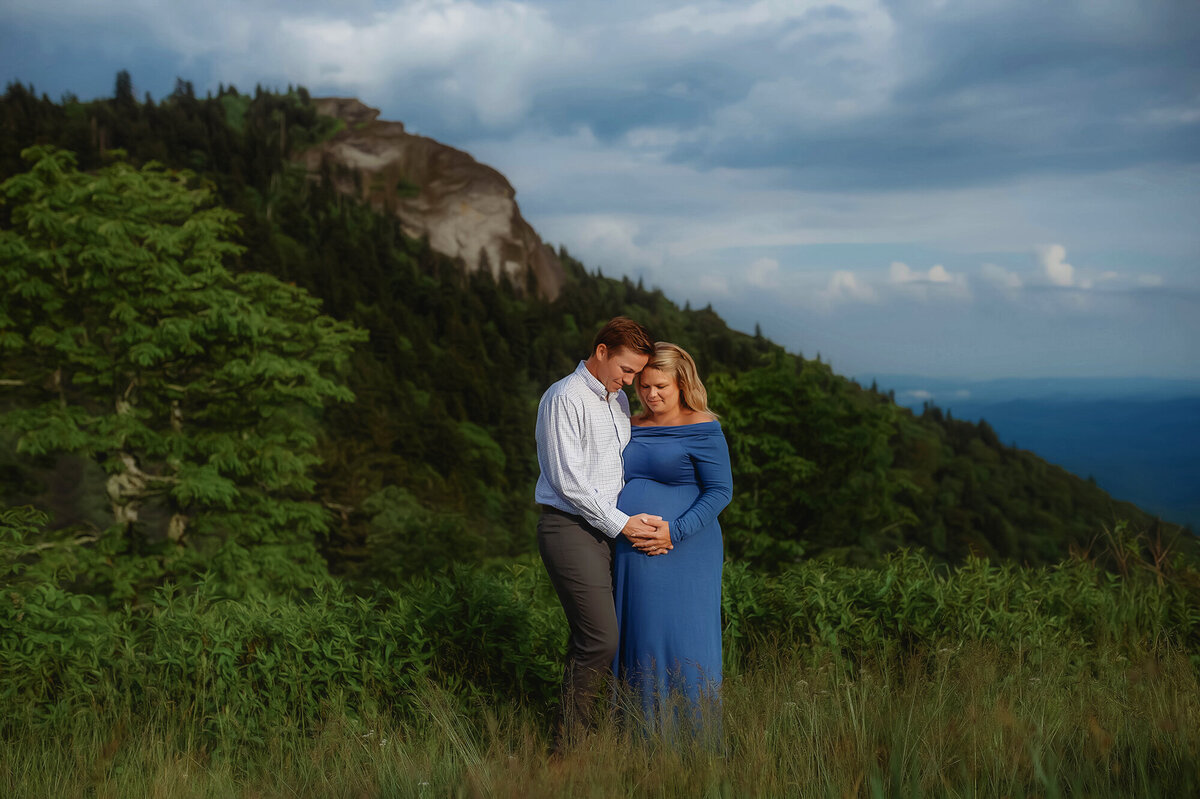 Expectant parents pose for Maternity Photos on the Blue Ridge Parkway in Asheville, NC.