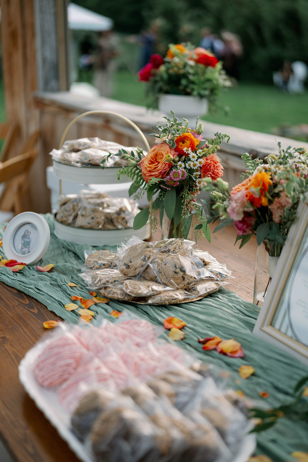 Styled dessert table featuring colorful treats at a fall orchard wedding reception at The Cherry Barn at Nugent Orchards in Frankfort, Michigan.
