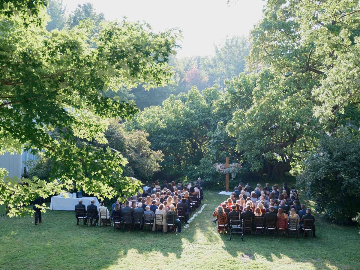 Outdoor wedding ceremony under clear blue sky.