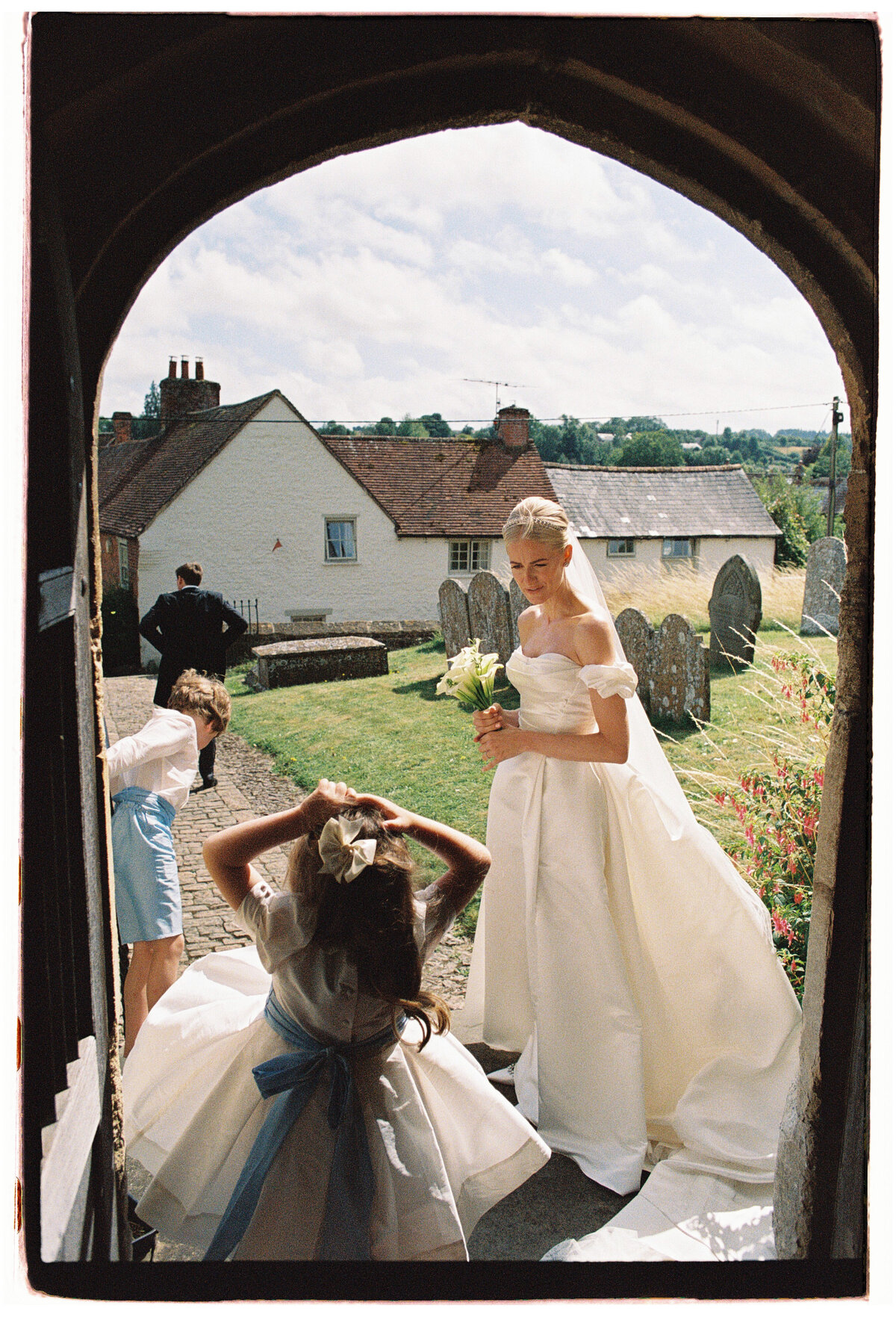 Bride and groom after ceremony during their Wiltshire film wedding, captured by Kate Winters Photography.