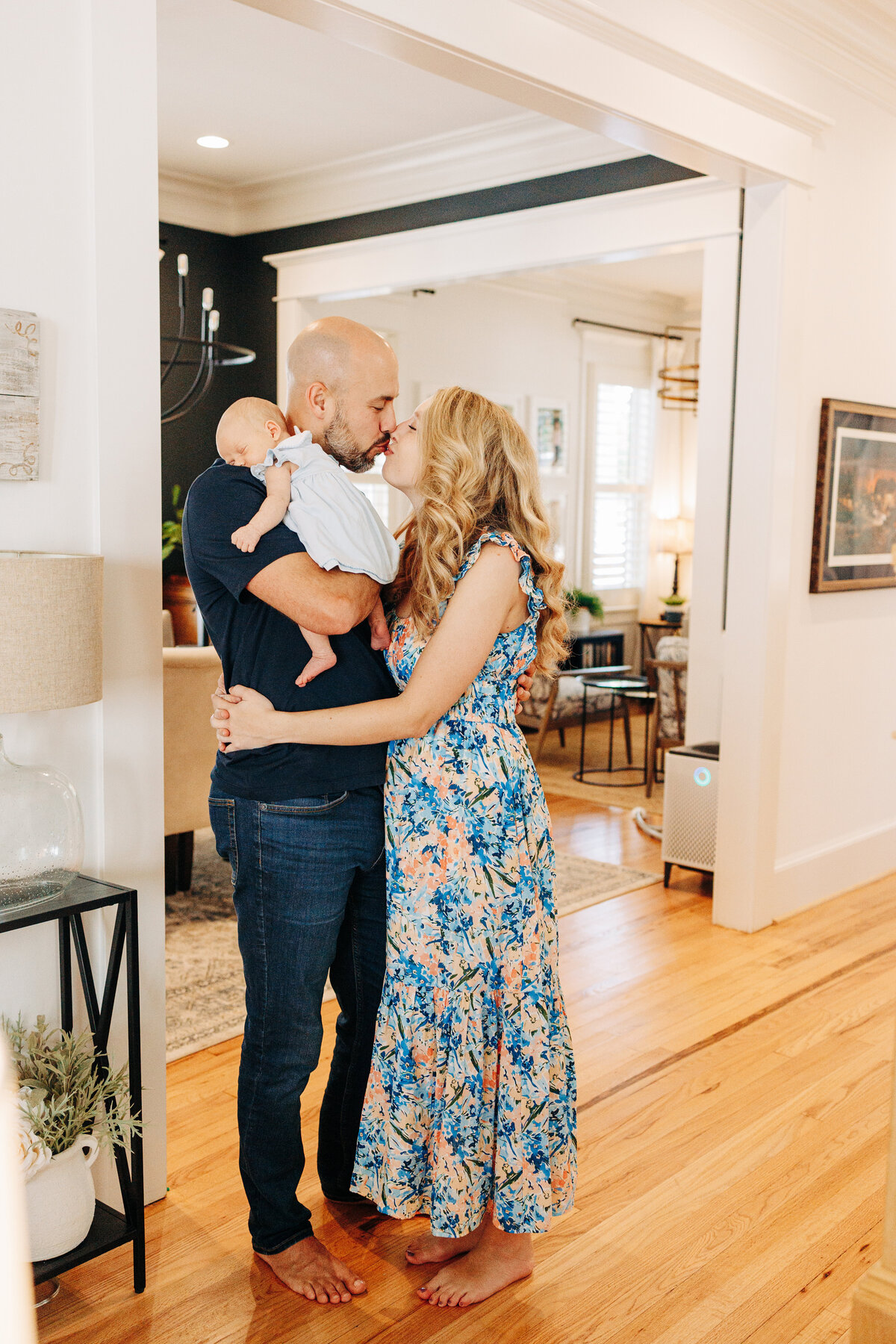 couple with their baby kissing