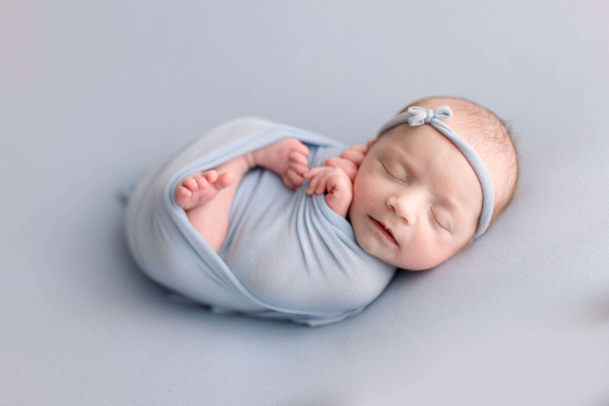 Baby girl swaddled up in Woodinville photography studio