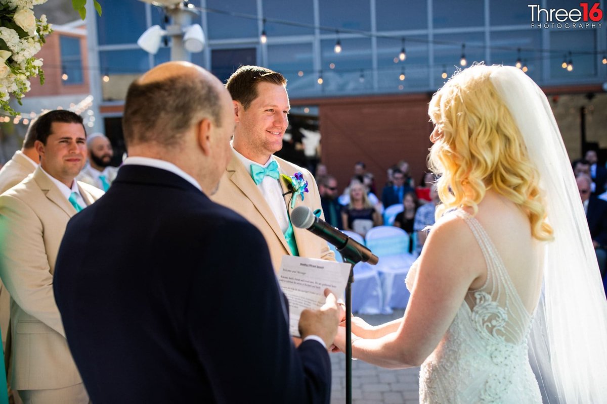 Groom smiles at his Bride during the wedding ceremony