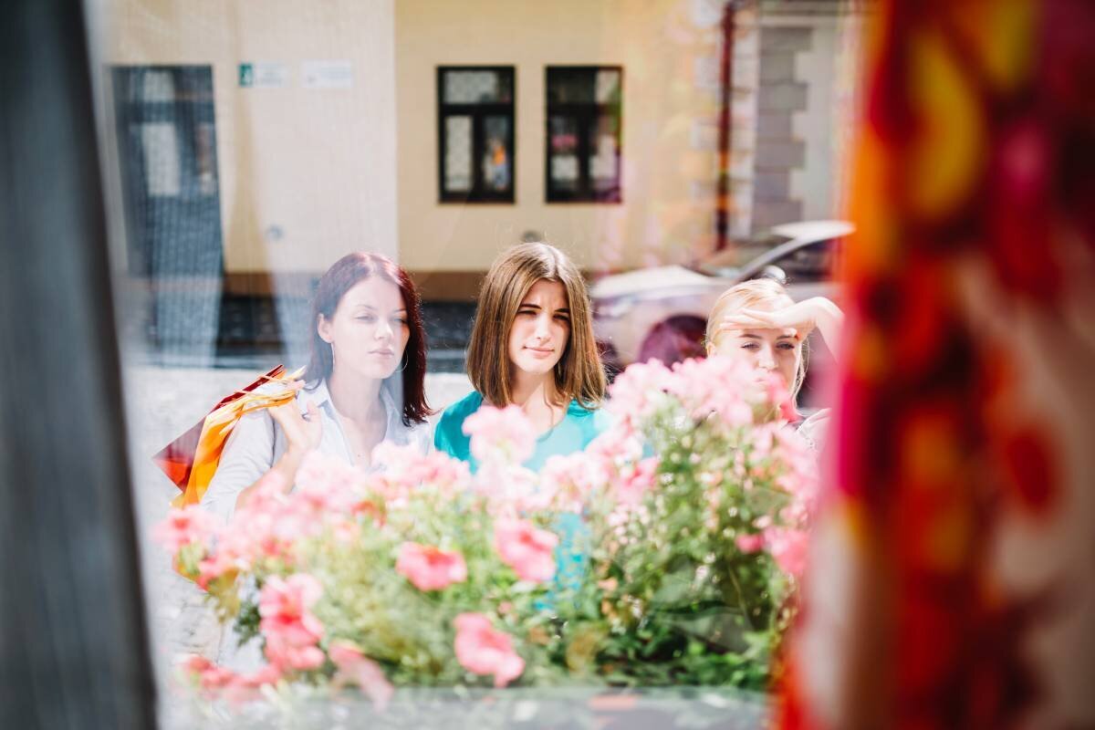 three-women-looking-through-shop-window