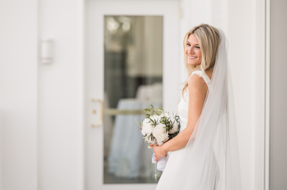 bride at the pittsburgh field club smiling and looking at the golf course