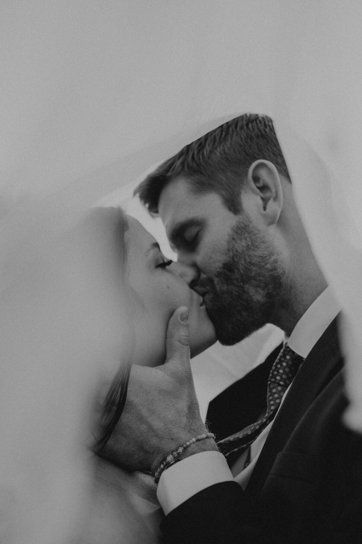 bride and groom kissing during wedding