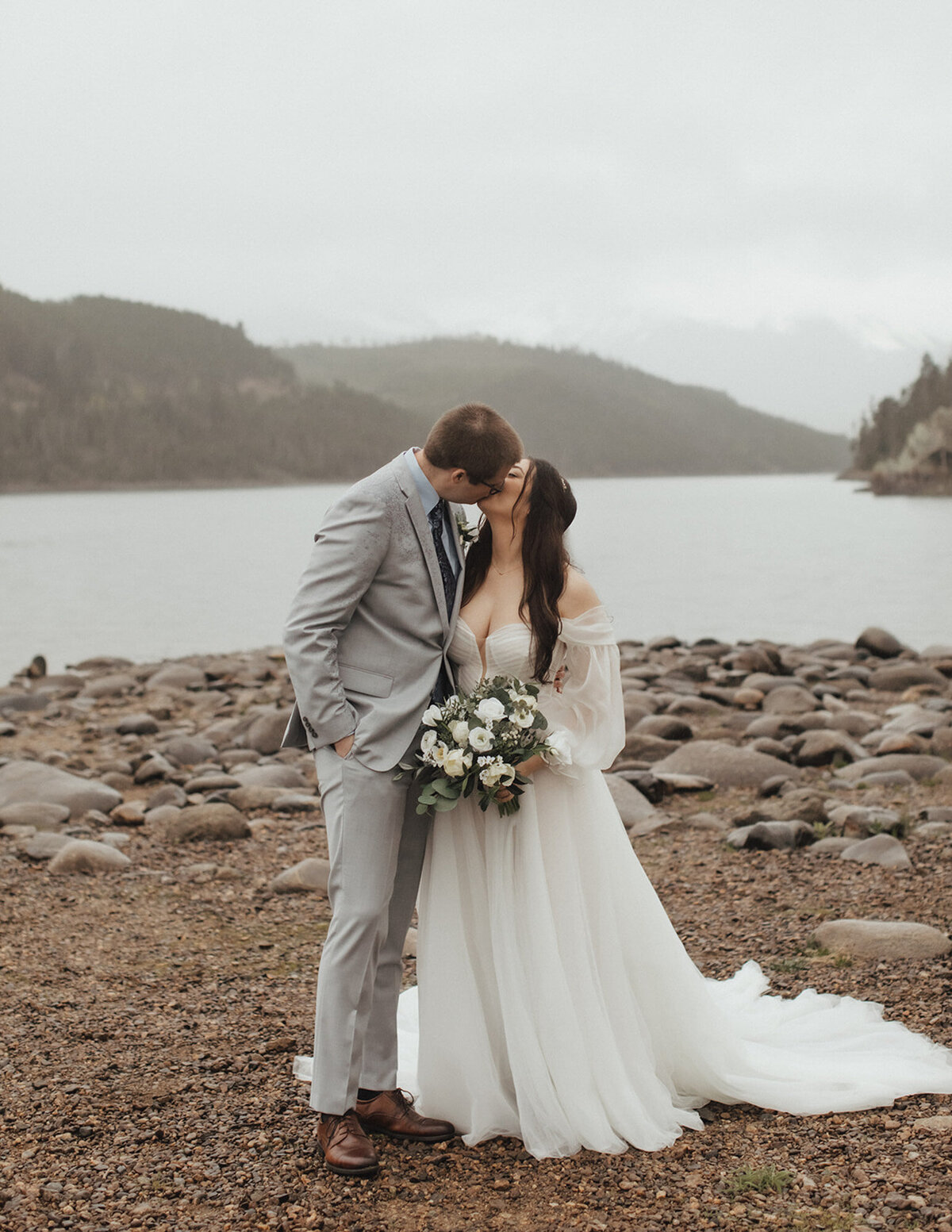 Cerise and Geoff happily kissing at the lakeside