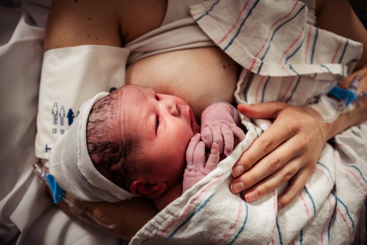 A husband helps support his wife through contractions during labor