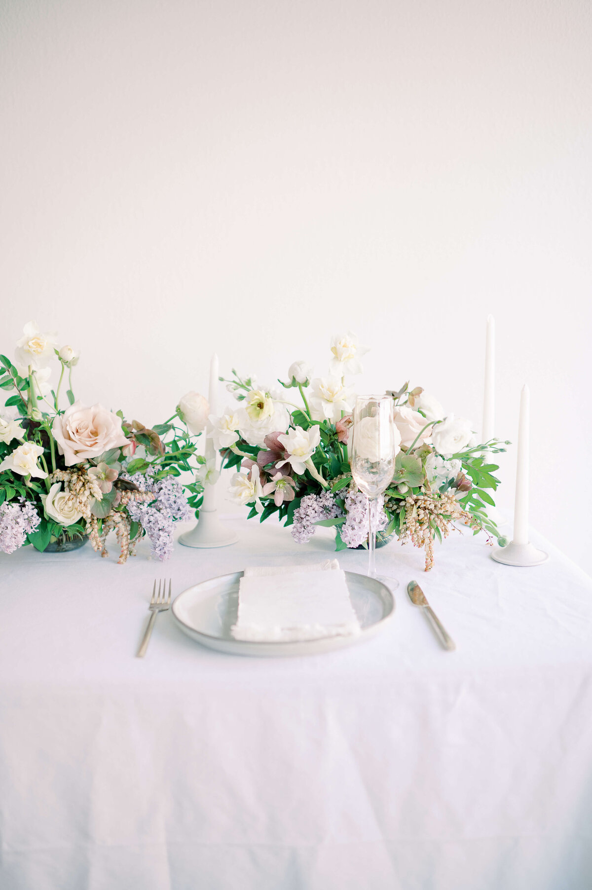 wedding table place setting with floral arrangements