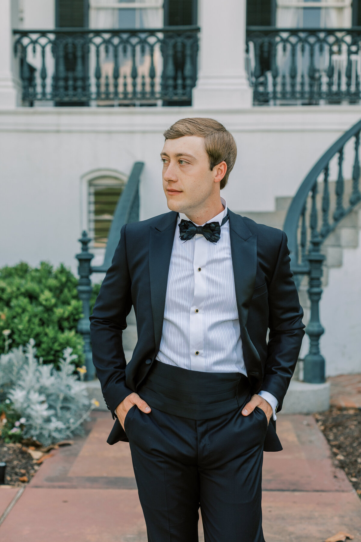 A classic groom walks in front of Nottoway Plantation.