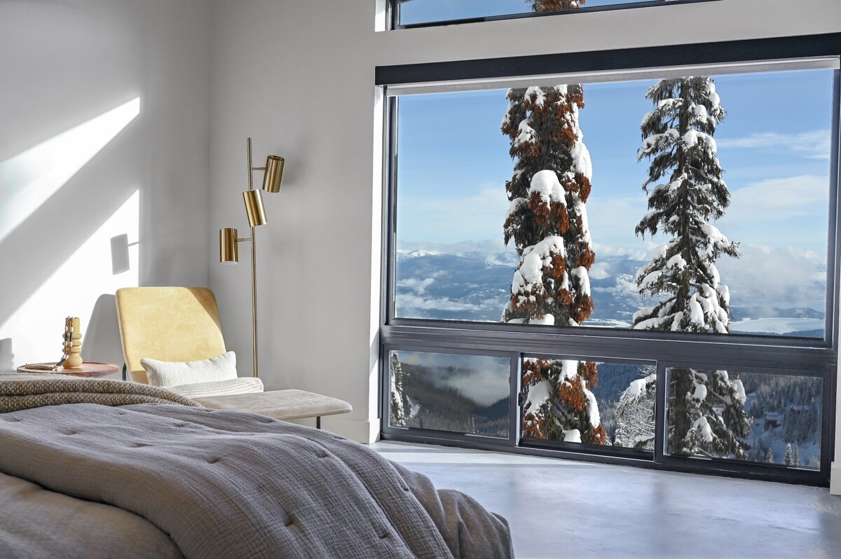 Blu dot furniture featured in this scandanavian mountain modern master bedroom. Concrete floors and expansive windows overlooking Sandpoint Idaho.