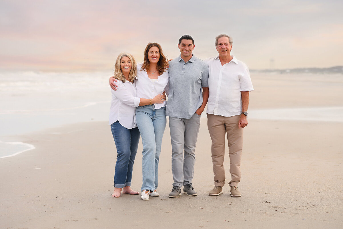 Family poses for Family Portraits on Isle of Palms beach in Charleston, SC.