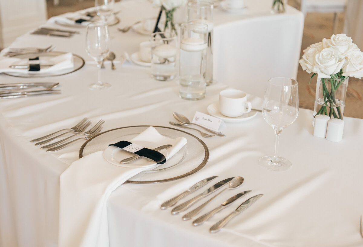 Elegant wedding dinner reception place settings with white and black accents