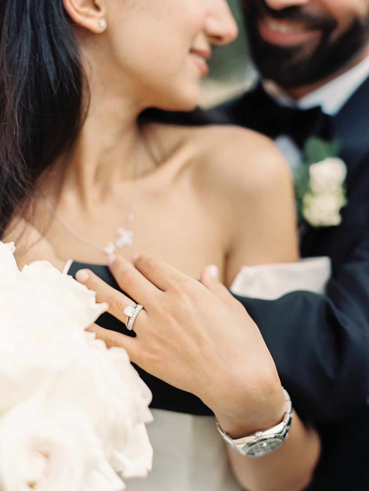 a bride and groom snuggling into one another and holding hands