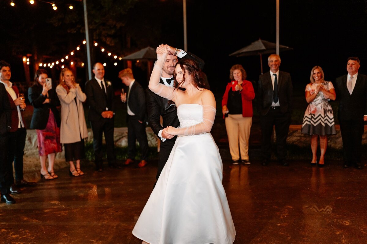 A blissful moment captured: a couple joyfully dances at their wedding reception, encapsulating love and celebration in a single frame.