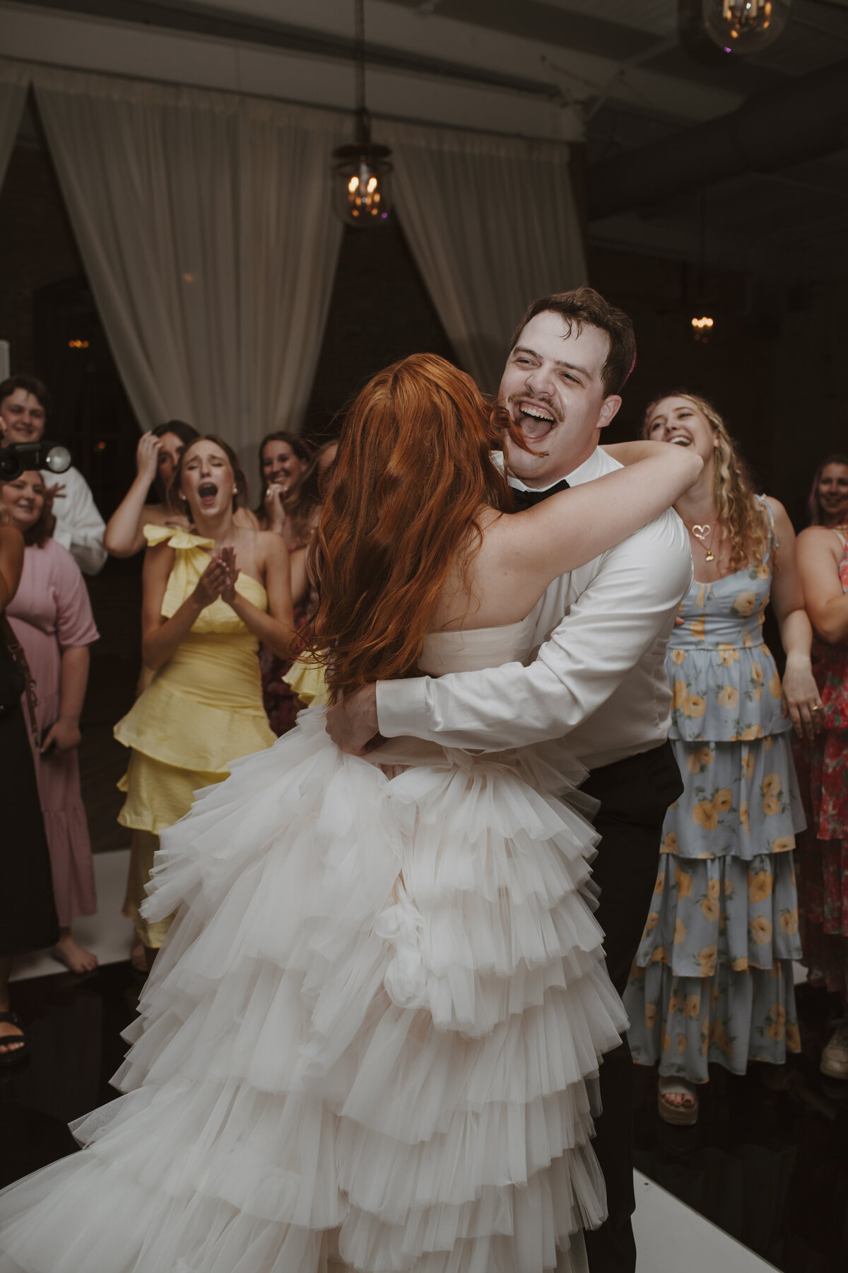bride and groom hugging on dance floor