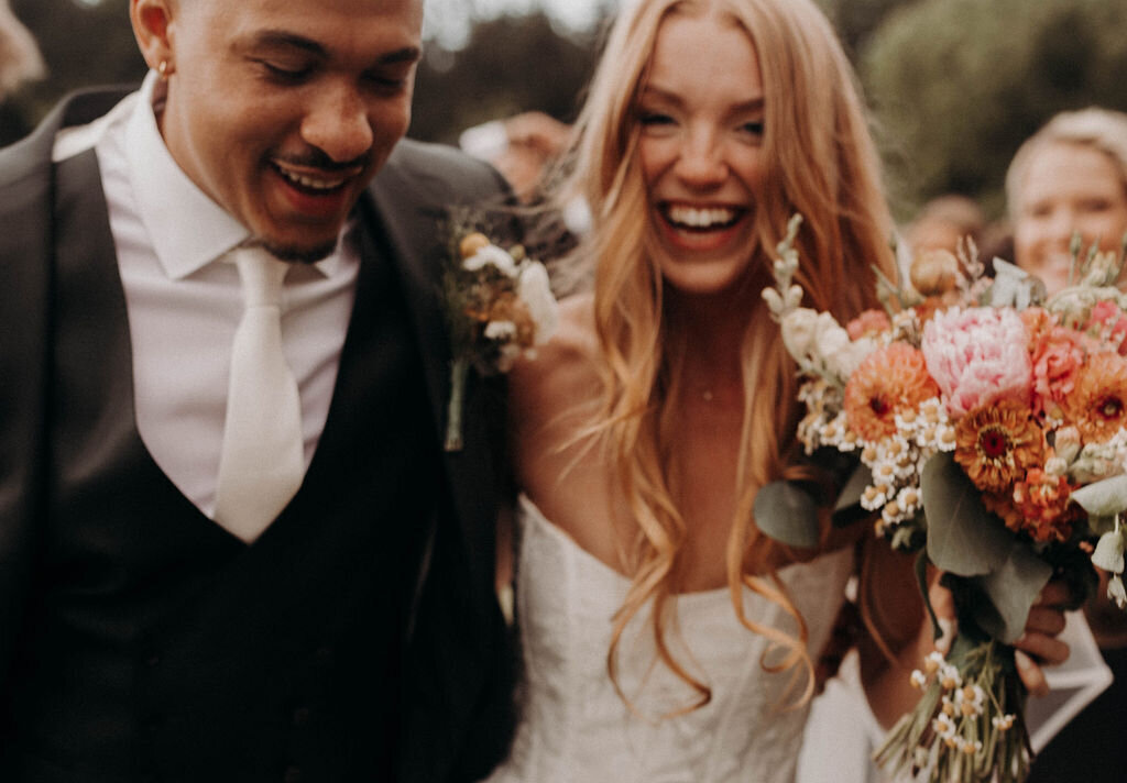 joyful wedding photographer bride and groom interracial couple