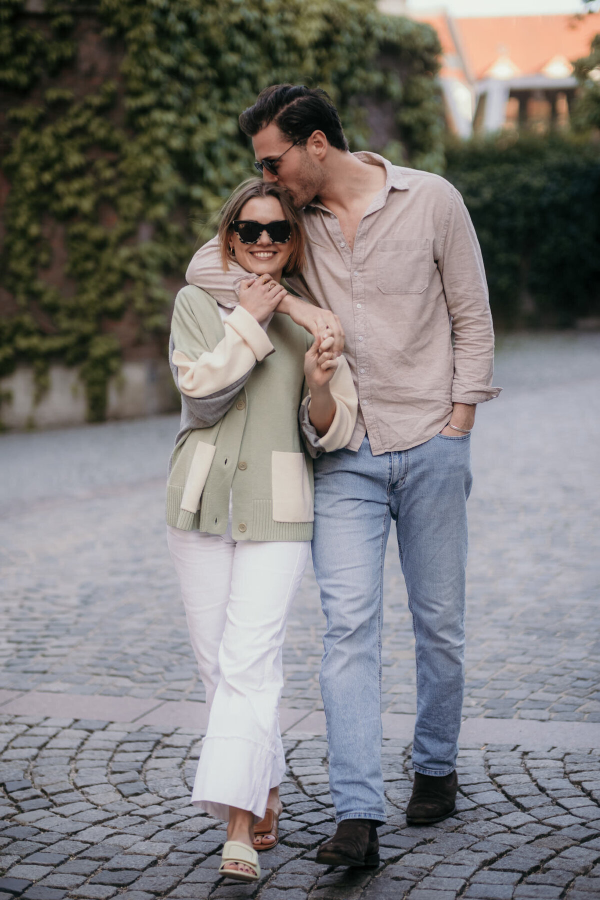 Couple photography walking through an empty street.