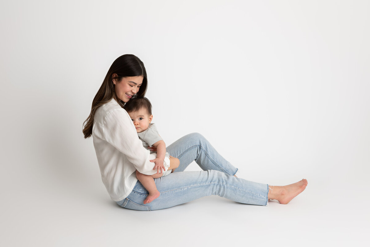 Mom and son on white seamless paper backdrop
