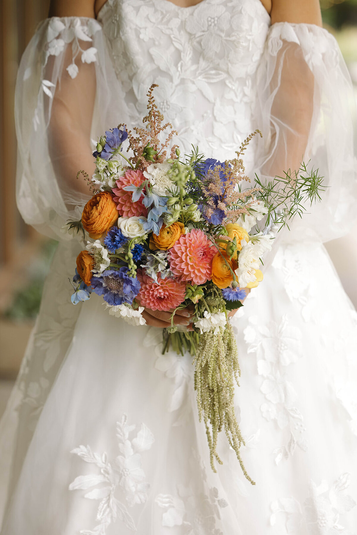 Bride holding a bright wildflower bouquet