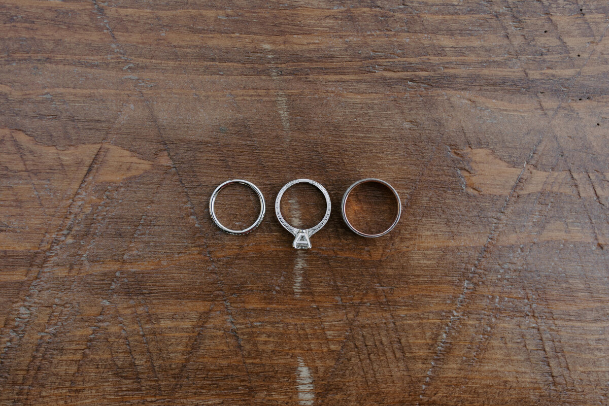 three rings laid out on a wood table