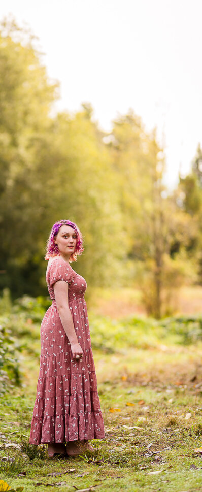 senior-portrait-girl-in-pink-dress-forest-backdrop