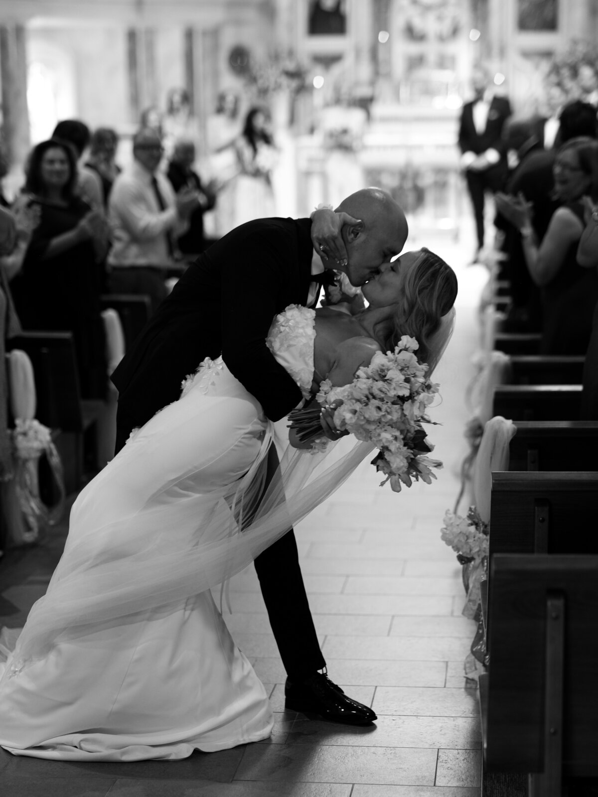 bride and groom kissing after marrying at a church in southern California