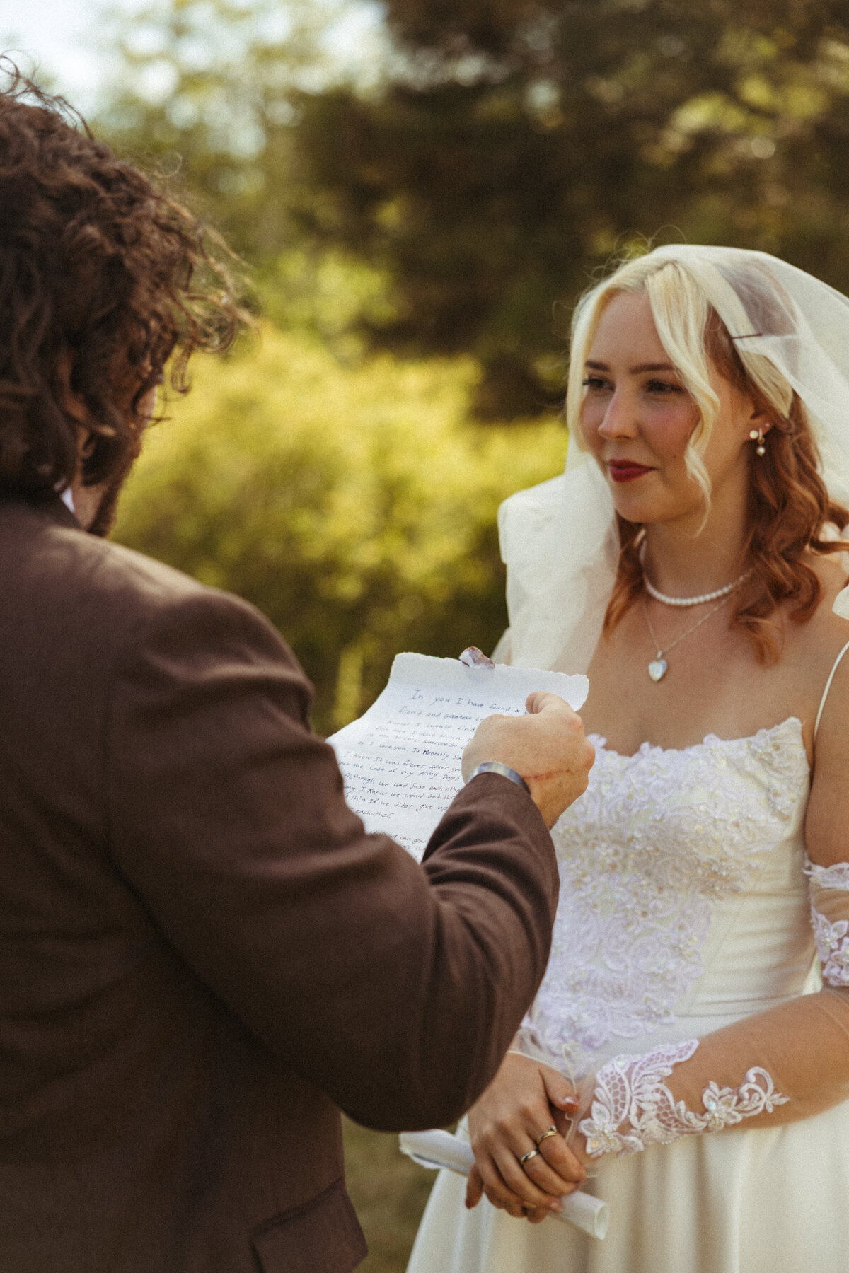 Groom reads handwritten vows to his bride during an elegant intimate wedding in Cleveland, Ohio
