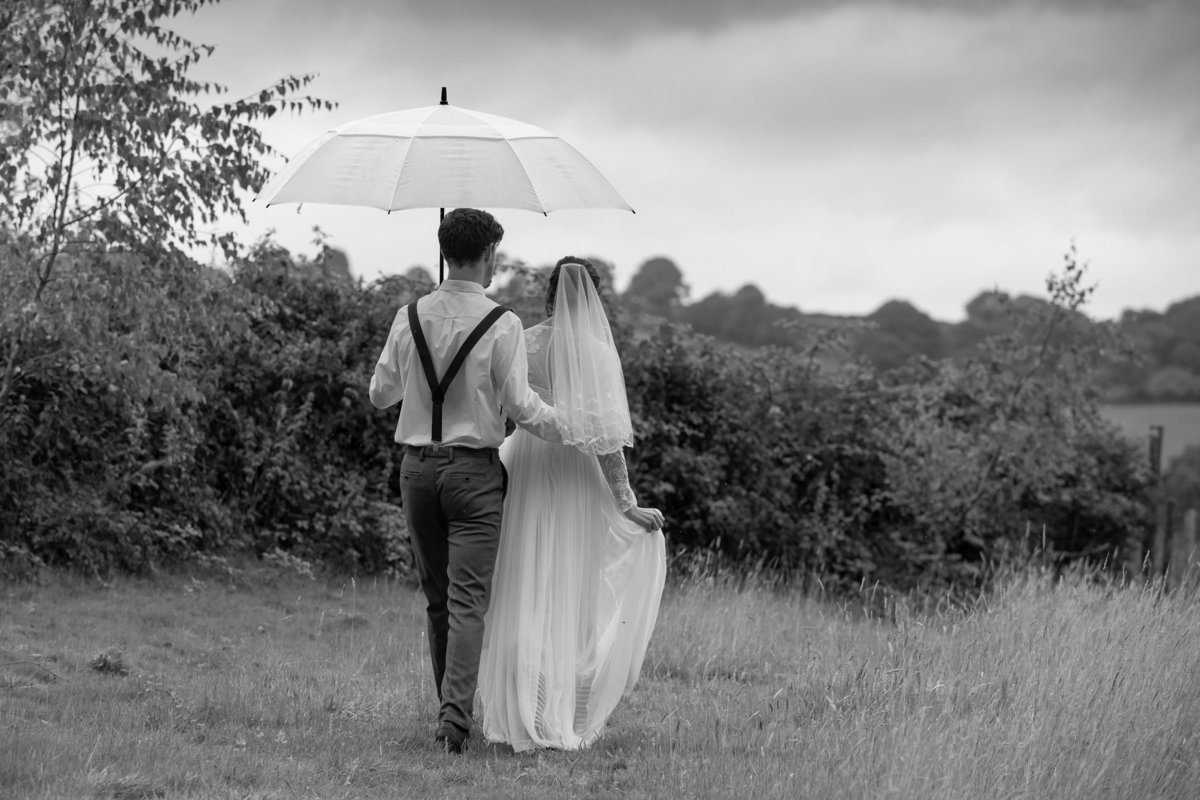 Black and white wet wedding photo at The Green weddings in Cornwall