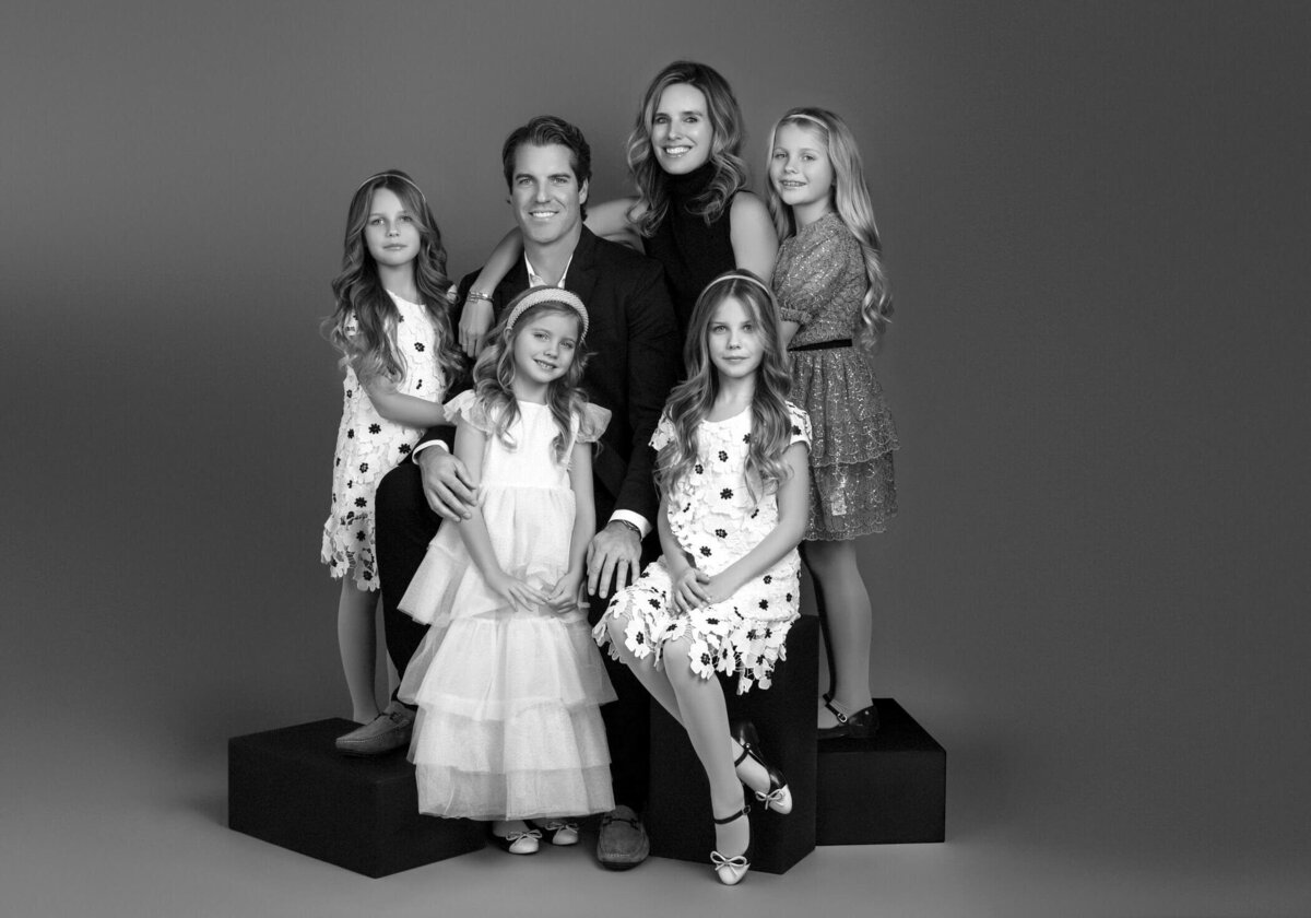 Black and white family portrait with children.