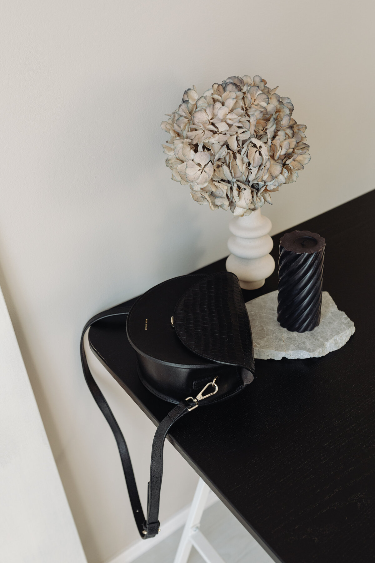kaboompics_desk-black-candle-dried-flower-black-leather-bag-24840