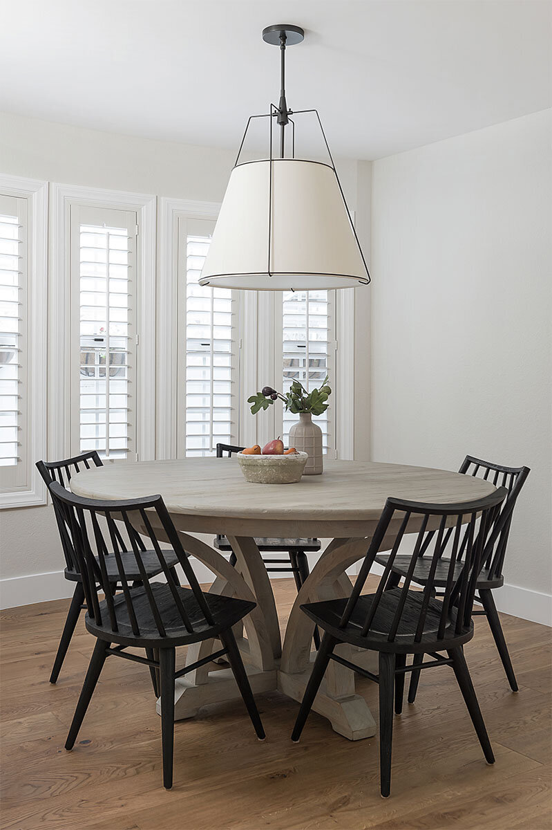 pendant light over dining table black chairs