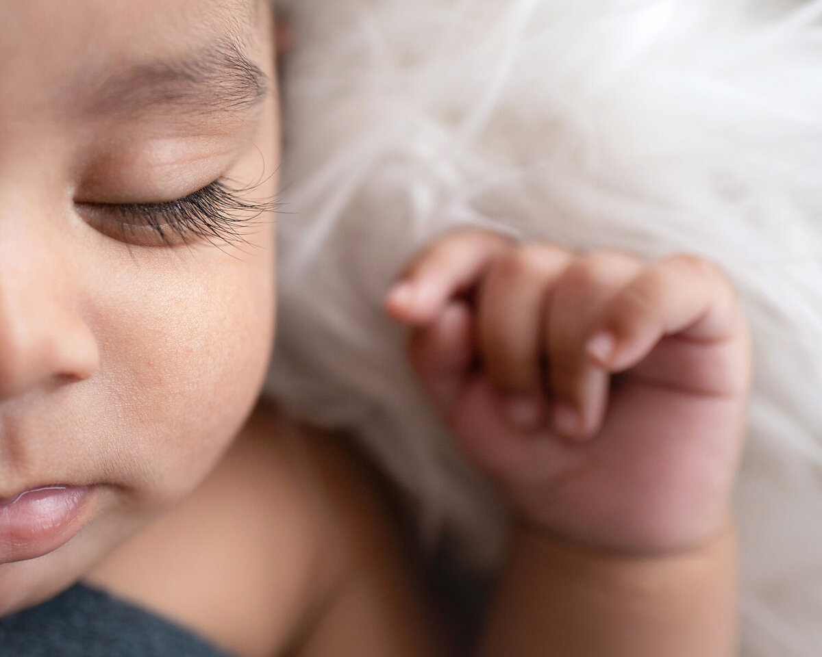 Close up image of a 2 month old baby boy's gorgeous long eyelashes during his newborn session with Susan Baraban Photography.