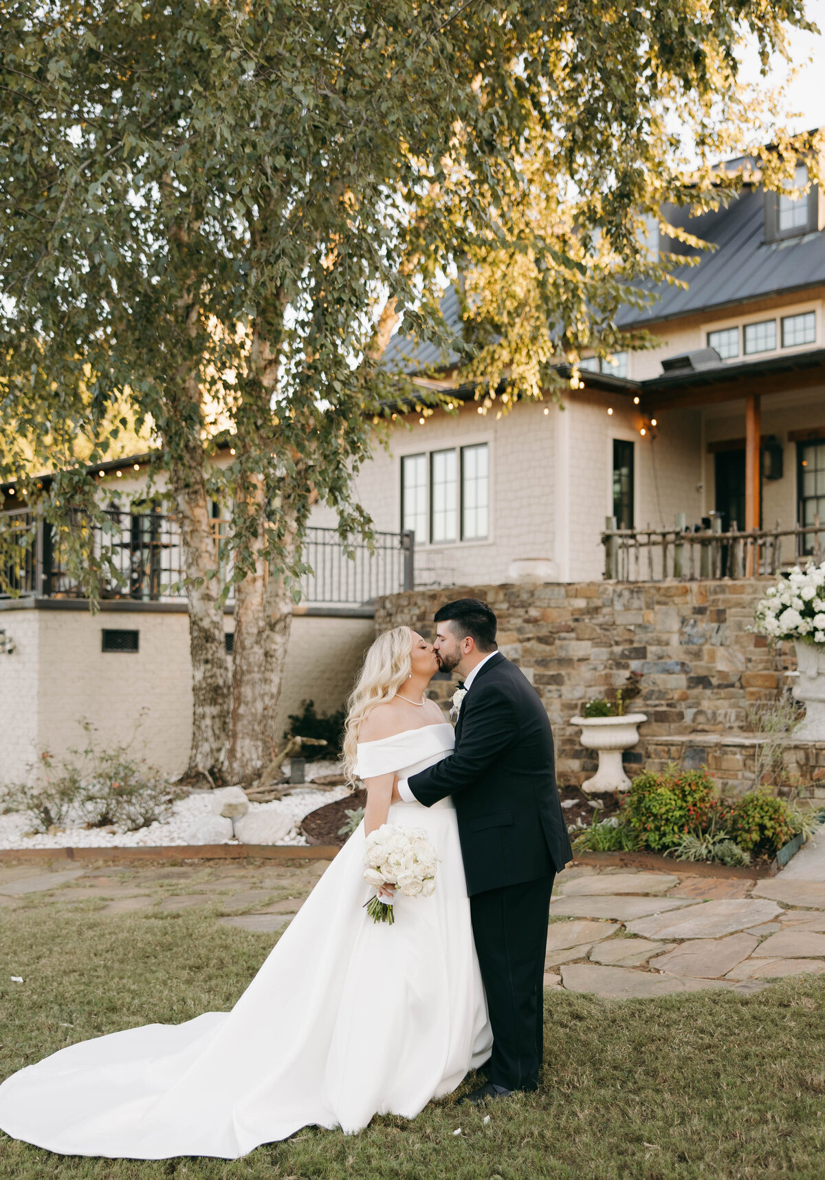 bride and groom kissing outside of Florence venue