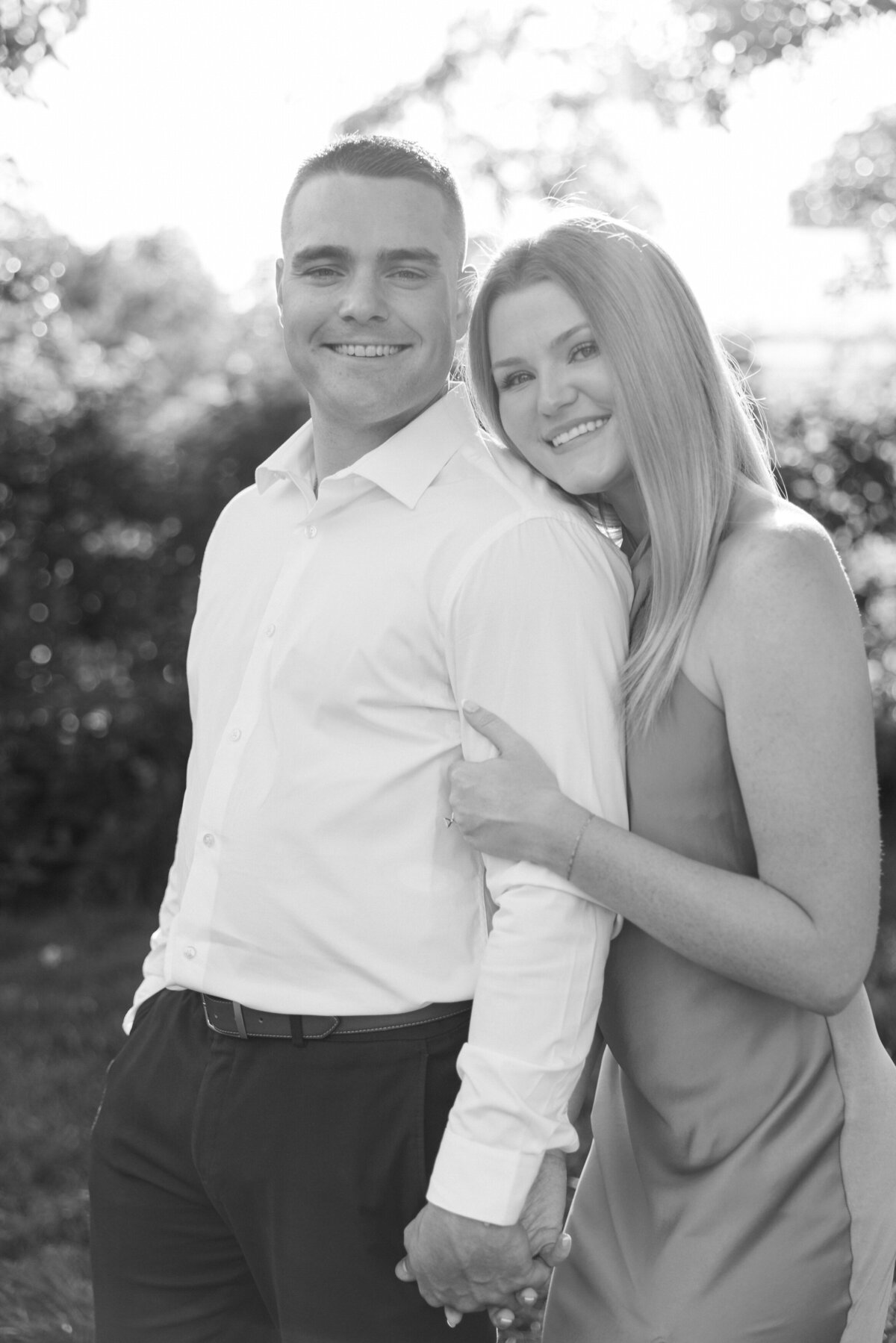 Black and white image of woman resting head on man's shoulder, Columbus session by Philadelphia photographer.