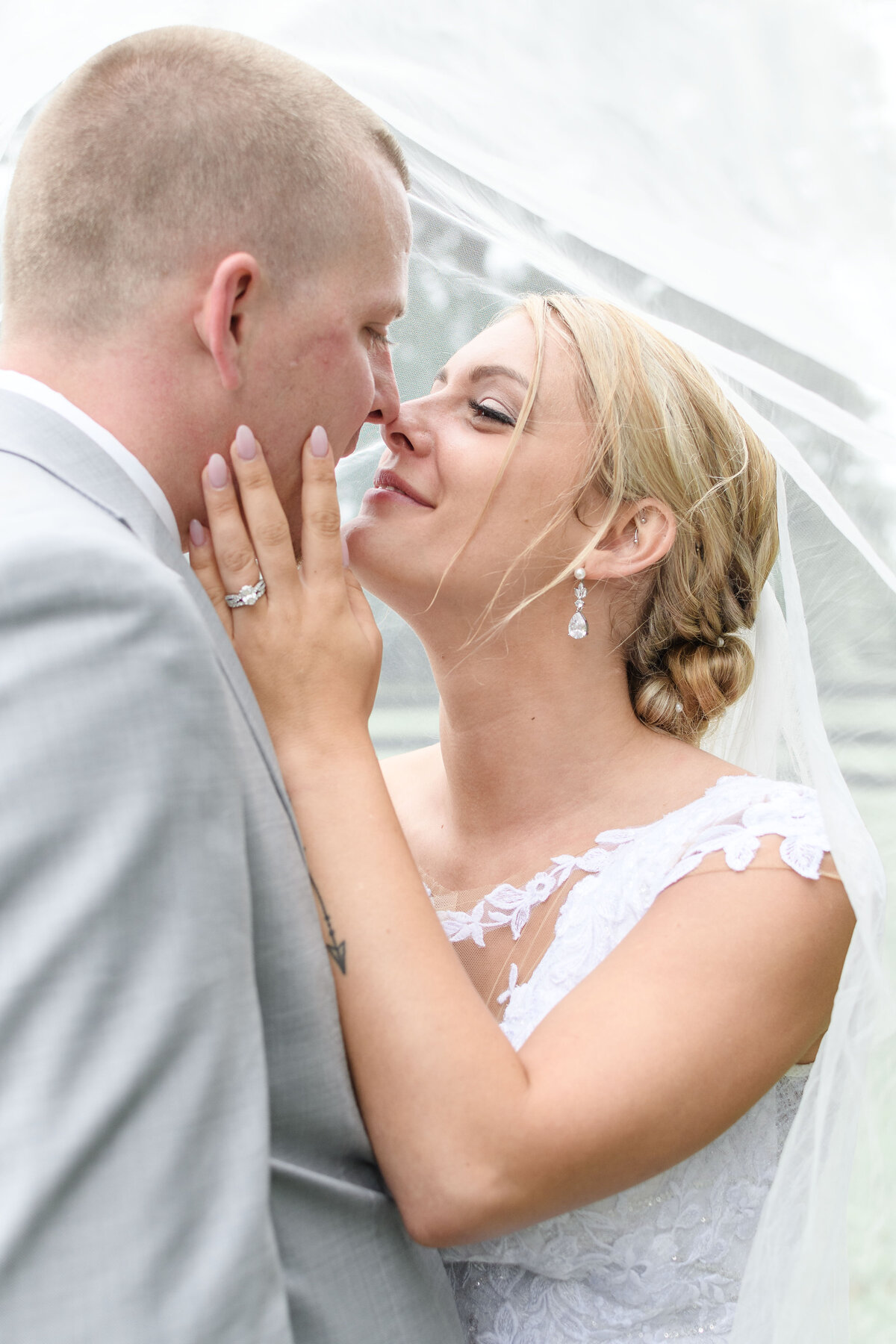 Ashley Hall Photography couple sharing a moment under the veil at Lakeside at Welch Estate
