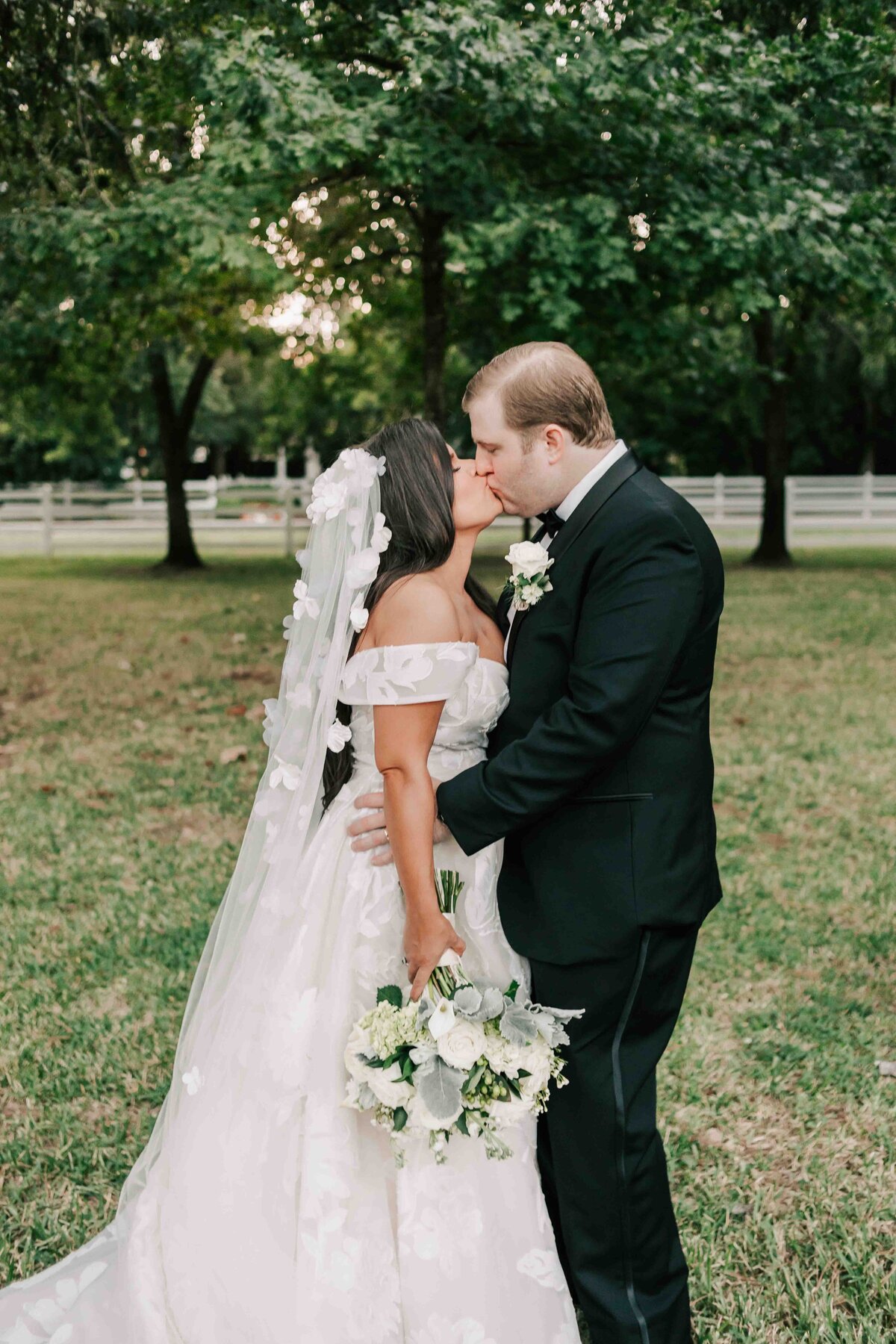 groom kisses his bride moments after their ceremony in houston texas at the forest club.