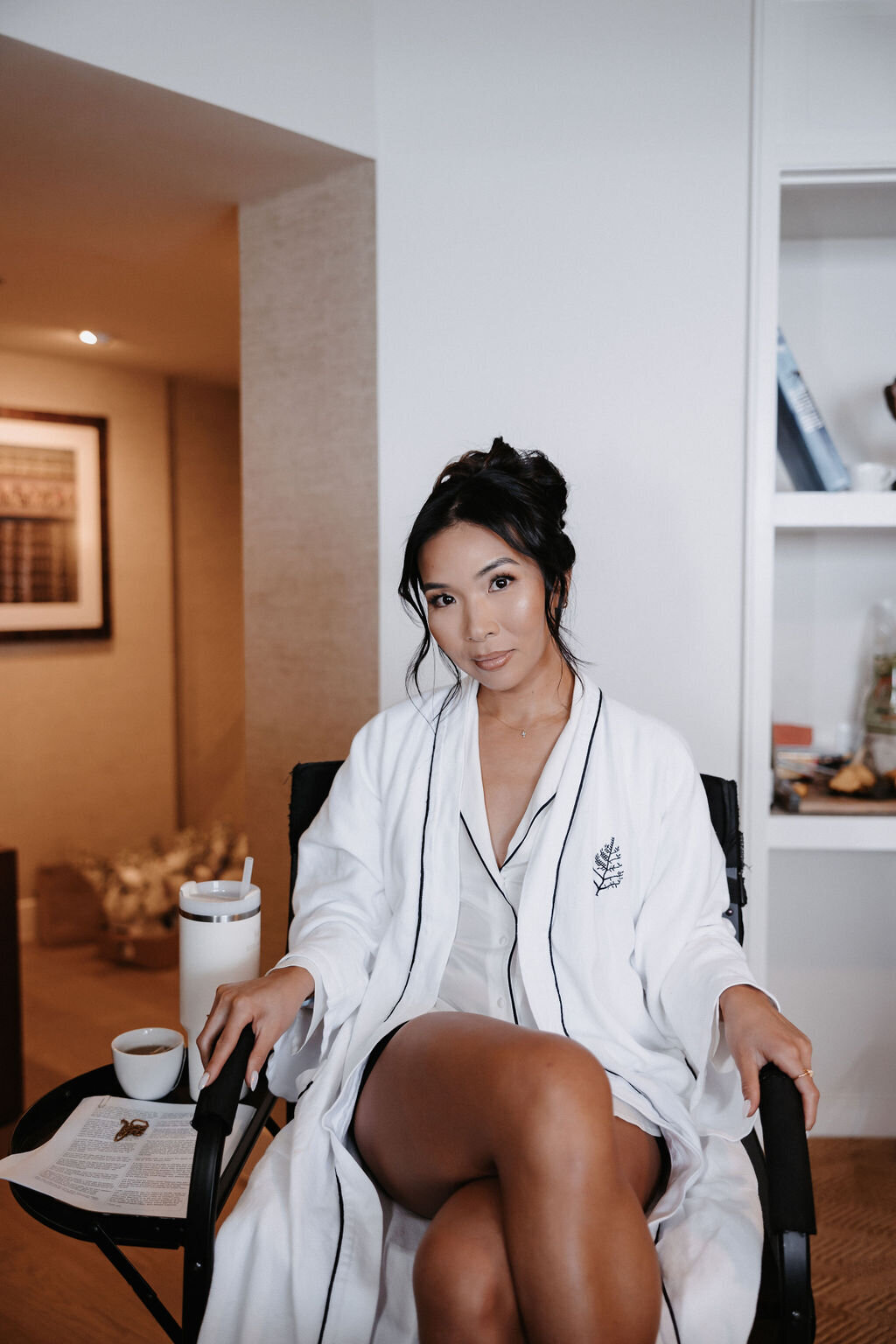 bride posing getting hair and makeup done at four seasons Oahu for her lanikuhonua wedding