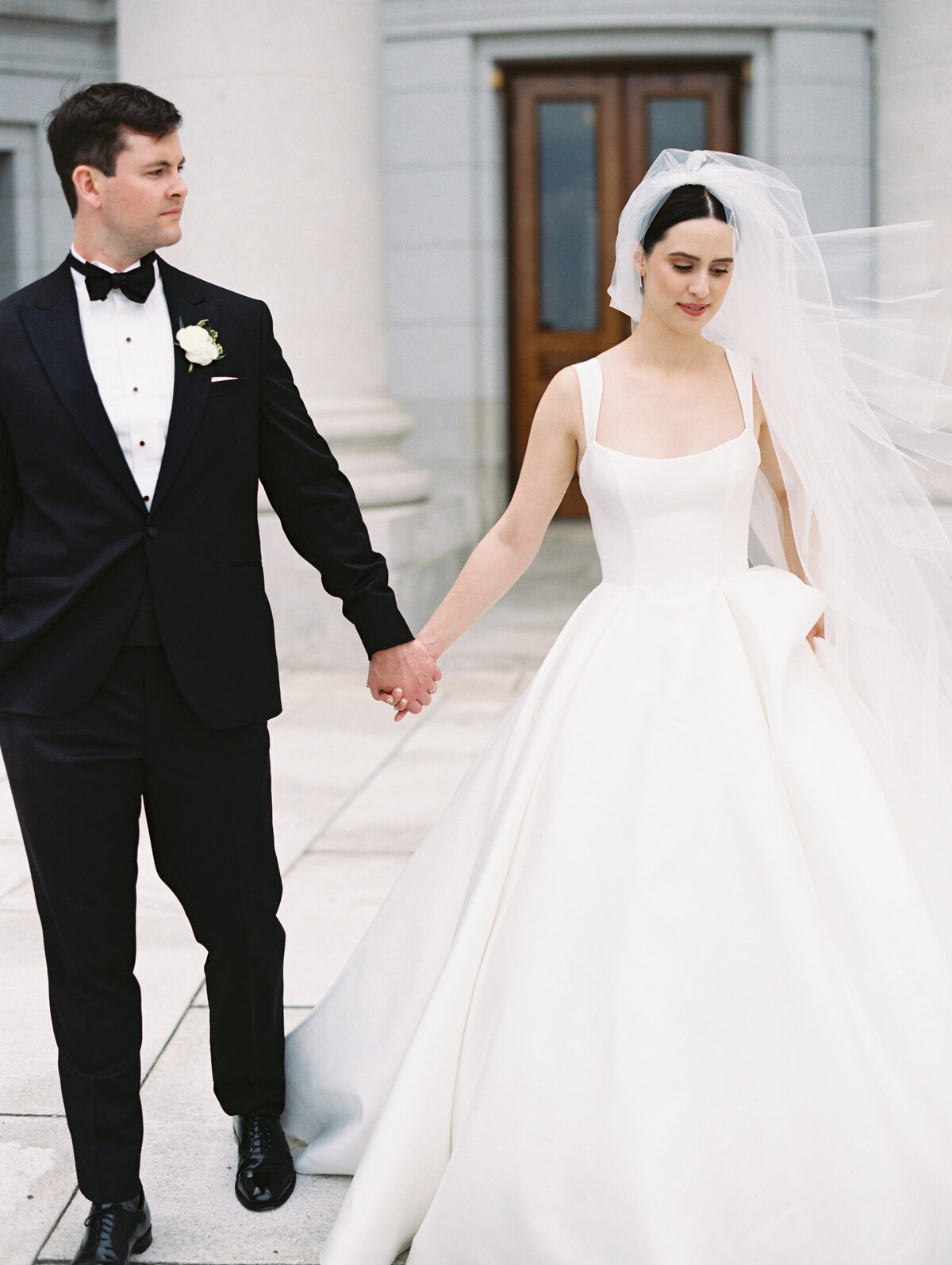 Bride and groom holding hands and walking to show wedding photos chicago by Allison Francois Photography
