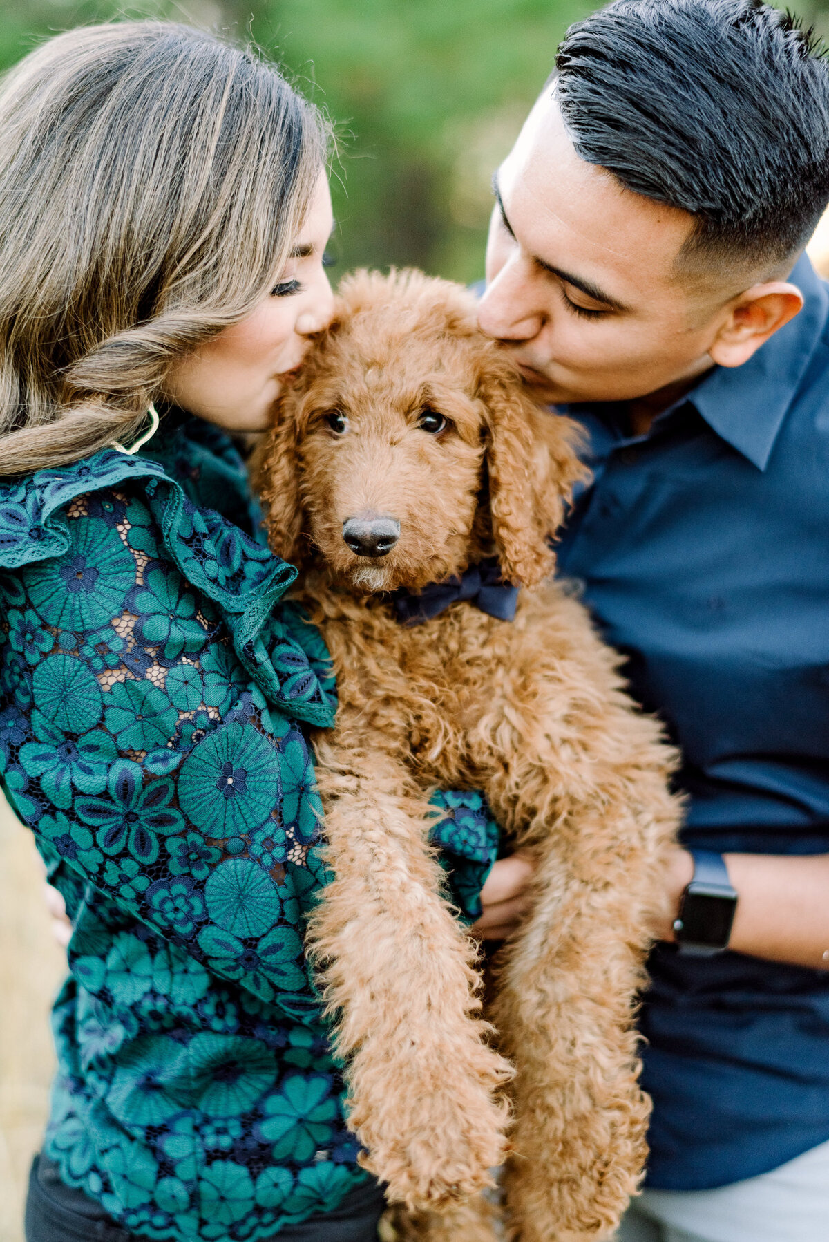 snuggly golden doodle photo with engaged couple