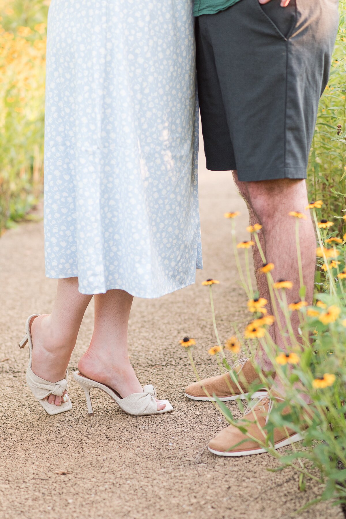 close up of feet white heels blue floral dress