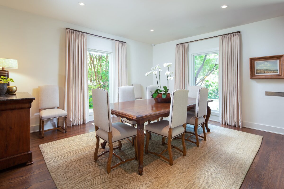 the keeping room interiors grant dining room table with a white orchid on table