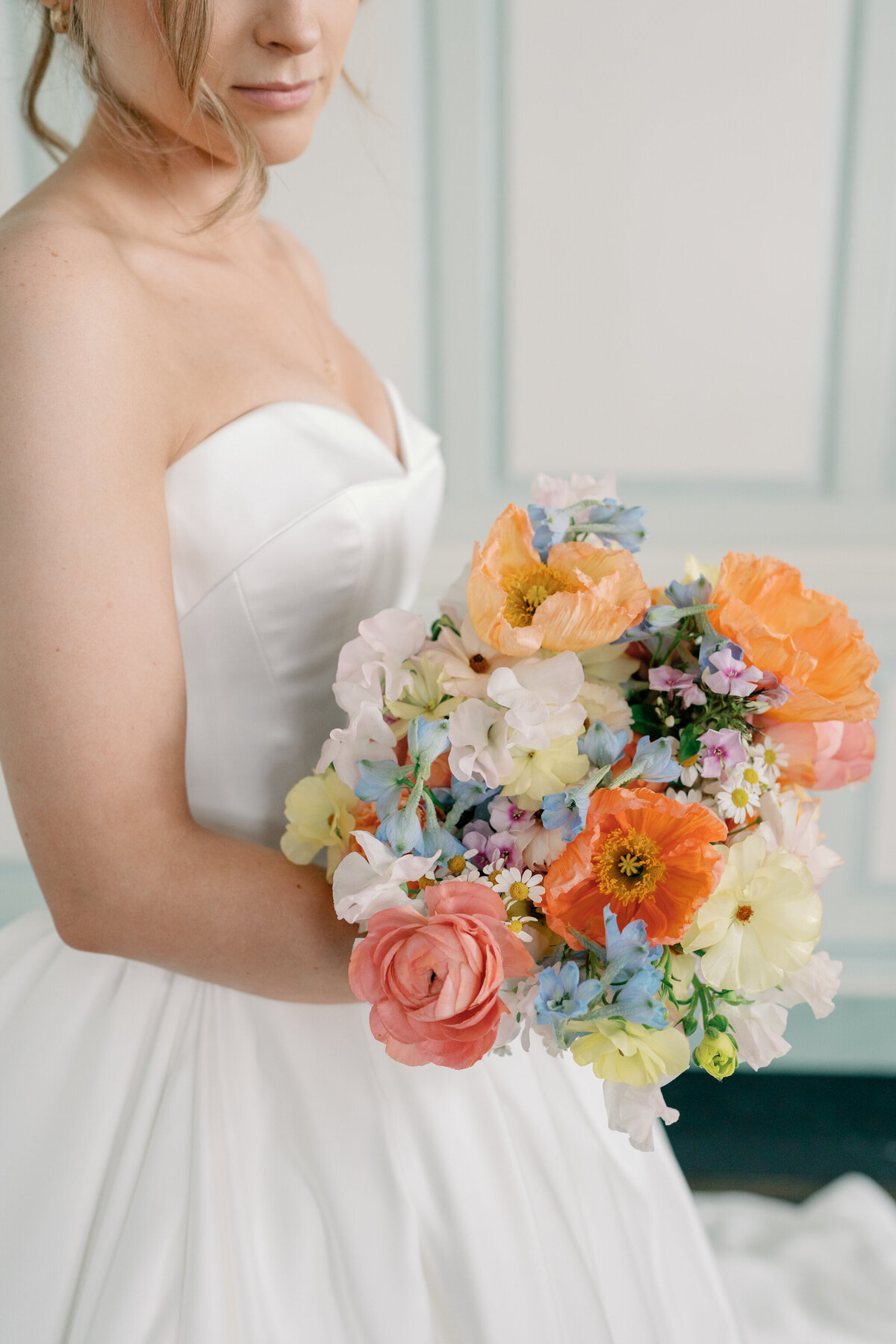 Wedding at the Estate at River Run in Maidens, VA | Wedding Photographer in Richmond | bride looking down at her colorful wedding bouquet in her Richmond wedding venue