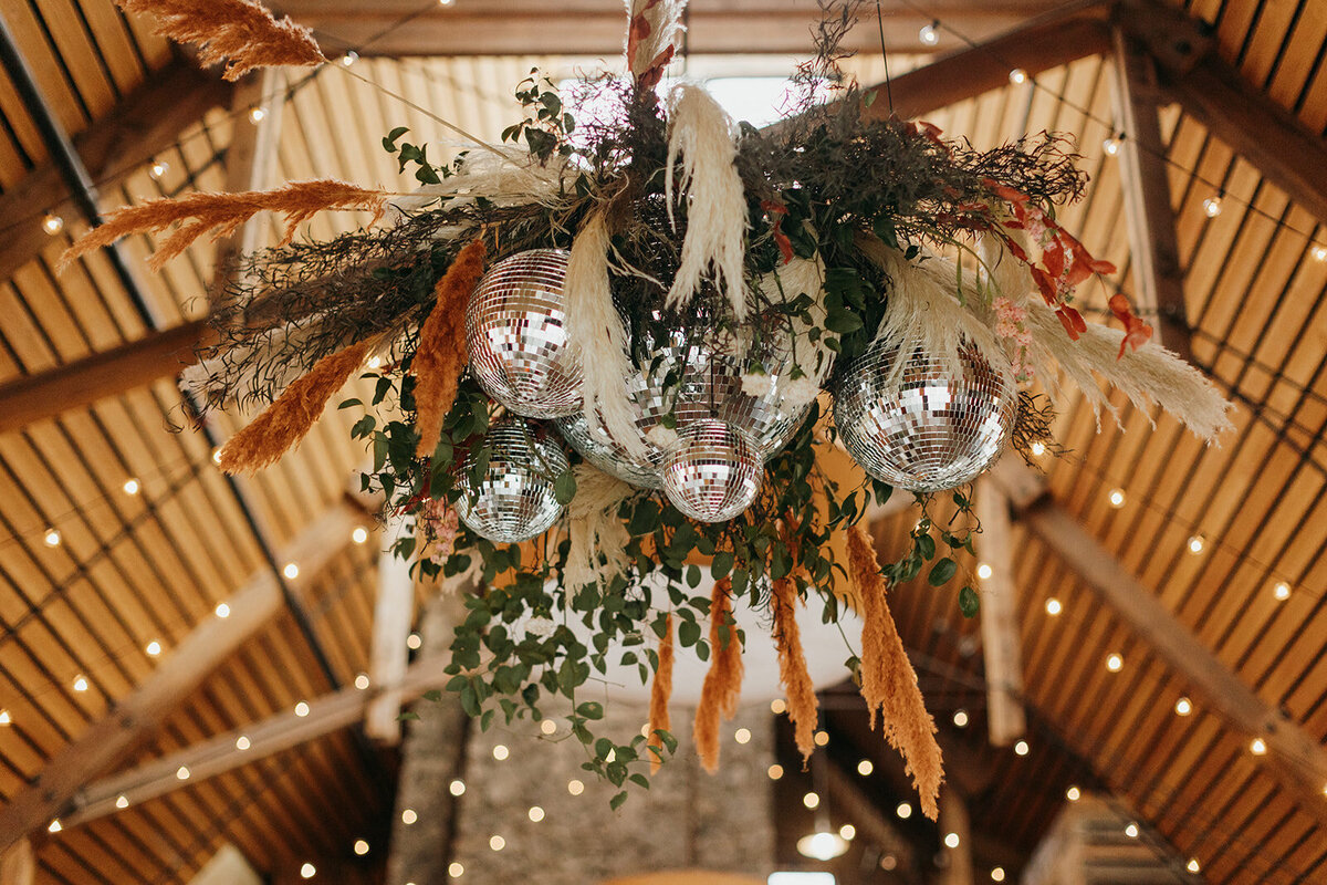 Disco ball chandeliere with greenery and pampas grass at the Barn at Brasada Ranch in Powell Butte Oregon
